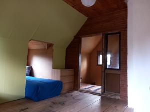 a bedroom with a blue bed and a mirror at Kisfaludy Apartment House in Gárdony