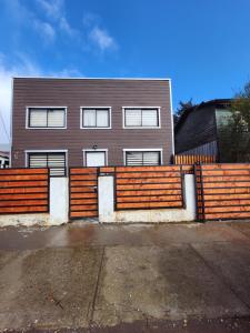 a wooden fence in front of a house at Cabañas Roma in Valdivia