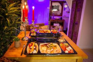 a table with three trays of food on it at Duo Détente in Le Chenoy
