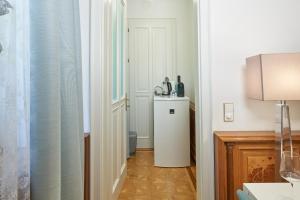 a hallway with a white door and a table in a room at Exclusive Entry: Cozy Guestroom in Baden