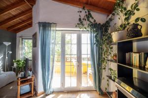 a living room with a sliding glass door at Lightbooking Claudia Hermigua La Gomera in Hermigua