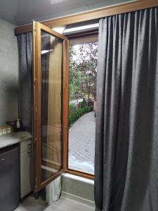 a window in a kitchen with a curtain at Villa Platinum in Tskaltubo