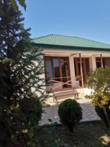 a house with a bench in front of it at Villa Platinum in Tskaltubo