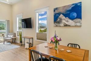 una sala de estar con una mesa de comedor con flores. en Stirling All Suites Hotel, en Nelson