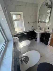 a bathroom with a white toilet and a sink at 17 Howard Road. Southampton in Southampton