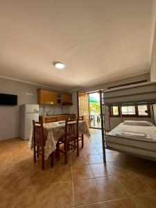 a kitchen and dining room with a table and a bed at HODO in Orikum