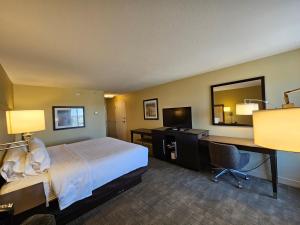 a hotel room with a bed and a desk with a computer at Hampton Inn Billings in Billings