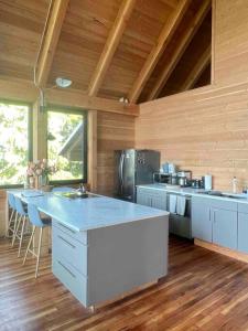 a large kitchen with a counter top in a room at Basecamp Strathcona Park View Chalet in Mount Washington