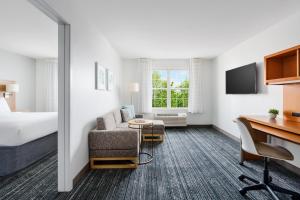 a hotel room with a bed and a desk at TownePlace Suites Manchester-Boston Regional Airport in Manchester