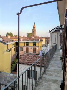 a view from the balcony of a building with a clock tower at Home4You in Cremona