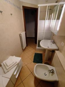a bathroom with a sink and a toilet at Home4You in Cremona +11 photos