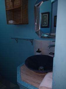 a bathroom with a large blue tub and a mirror at Lendal APT in Saint James