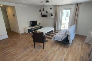 a living room with a table and a tv at Apartment Doppelhorst in Oberndorf in Oberndorf