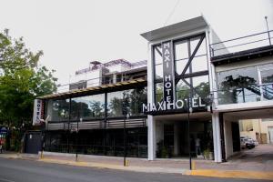 a large building with a sign on the front of it at Maxihotel Business Class Culiacan in Culiacán