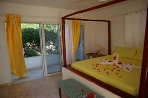 a bedroom with a bed and a mirror and a window at Villa SOL in Cumayasa Kilómetros 4 1/2