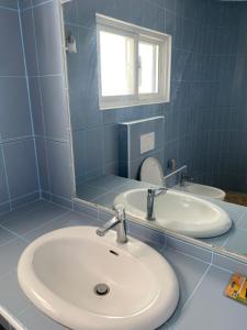 a bathroom with two sinks and a mirror at Villa SOL in Cumayasa Kilómetros 4 1/2