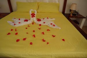 a bed with red rose petals on it at Villa SOL in Cumayasa Kilómetros 4 1/2