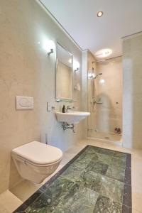 a bathroom with a toilet and a sink at Big Apartment in Guesthouse in Baden