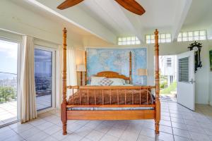 a bedroom with a canopy bed with a map on the wall at Honolulu Hideaway with Balcony City and Ocean View! in Honolulu