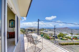 a balcony with chairs and a view of the city at Honolulu Hideaway with Balcony City and Ocean View! in Honolulu