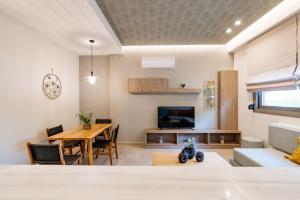 a living room with a table and a dining room at Iasmos Luxury Apartment in Heraklio