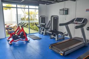 a gym with several exercise bikes and a treadmill at Aquamarina Hotel in Manta