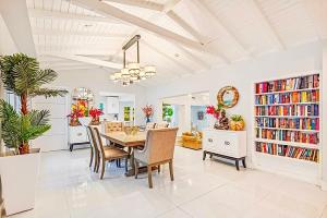 a dining room with a table and chairs and bookshelves at Coconut Grove, Miami FL in Miami