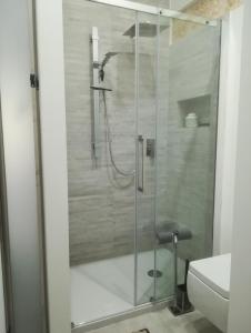 a glass shower in a bathroom with a toilet at Residenza Bagolino in Alcamo