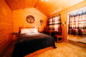 1 dormitorio con 1 cama en una cabaña de madera en La Junta Colorado Cabins, en La Junta