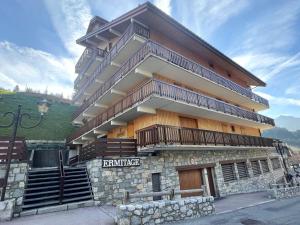 a large building with stairs on the side of it at Appartement au cœur de Méribel, 4 pers., balcon sud, proche pistes et commerces - FR-1-411-693 in Les Allues