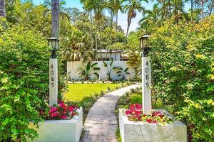 a path leading to a house with flowers and street lights at Coconut Grove, Miami FL in Miami