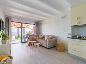 a living room with a couch and a table at Apartamento Primera Línea de Playa in San Bartolomé de Tirajana