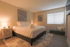 a bedroom with a bed with a teddy bear on it at Shabby Chic Oceanside King & 2 Queen bed Pool GYM in Oceanside