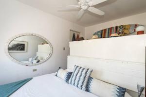 a bedroom with a ceiling fan and a mirror at Authentic Loft Retreat Steps from Beach & Culture in San José del Cabo +15 photos