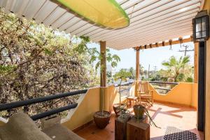 a balcony of a house with a patio at Authentic Loft Retreat Steps from Beach & Culture in San José del Cabo