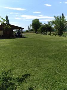 a large grass field with a pavilion in the distance at Cabañas RoFran in La Consulta