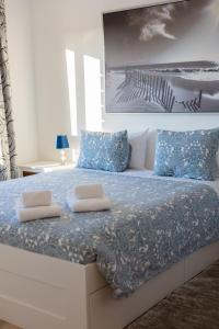 a bedroom with a bed with two pillows on it at KABACEIRA VILLAGE in Atalaia