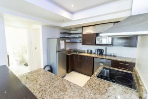 a kitchen with stainless steel appliances and a counter top at The Pearls 5th Floor Luxury Apartment in Port Elizabeth