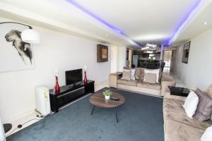 a living room with a couch and a table at The Pearls 5th Floor Luxury Apartment in Port Elizabeth