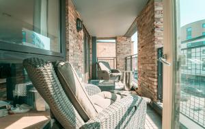 a balcony with two chairs and a fireplace at Luxury Greenwich 2Bed 2Bath Apt - Sleep 6 Guest- 1 min from station - close to Greenwich Maritime- Playstation provided in London