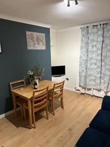 a dining room with a wooden table and chairs at Family or workers home - transport links & hiking in Porth