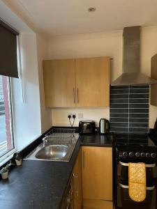 a kitchen with a sink and a counter top at Family or workers home - transport links & hiking in Porth