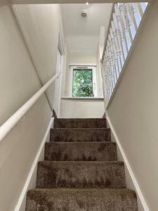 a staircase in a house with a window at Family or workers home - transport links & hiking in Porth