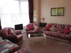 a living room with two couches and a coffee table at Sussex Hotel in Blackpool