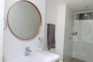a bathroom with a mirror and a sink and a shower at edificio astoria in Cali +11 photos