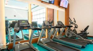 a gym with several cardio machines in a room at Centaurus Apartment Islamabad in Islamabad