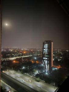 a night view of a city with a tall building at Centaurus Apartment Islamabad in Islamabad