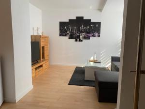 a living room with a couch and a television at Ferienwohnung Herborn in Herborn