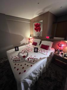 a bedroom with a bed with red hearts on it at Apartamento Luxo Recife in Recife