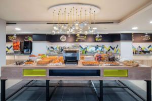 a buffet line with food on display in a restaurant at Hampton by Hilton Birmingham Broad Street in Birmingham